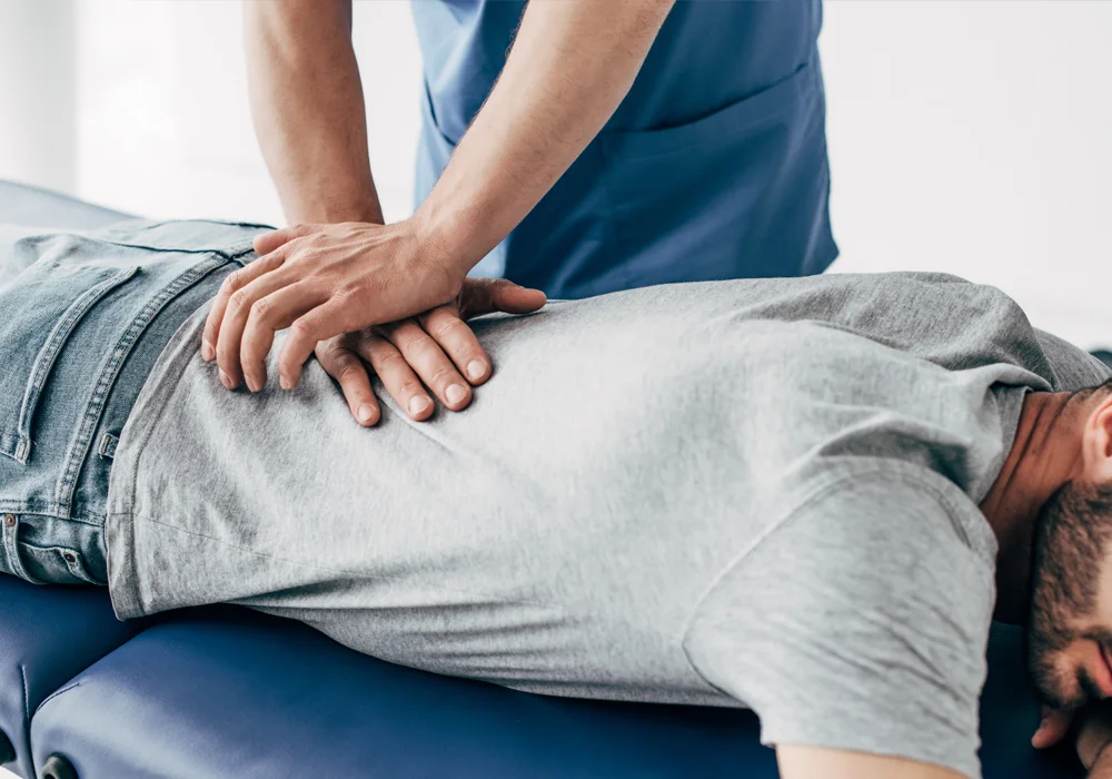 A person receiving a back adjustment.